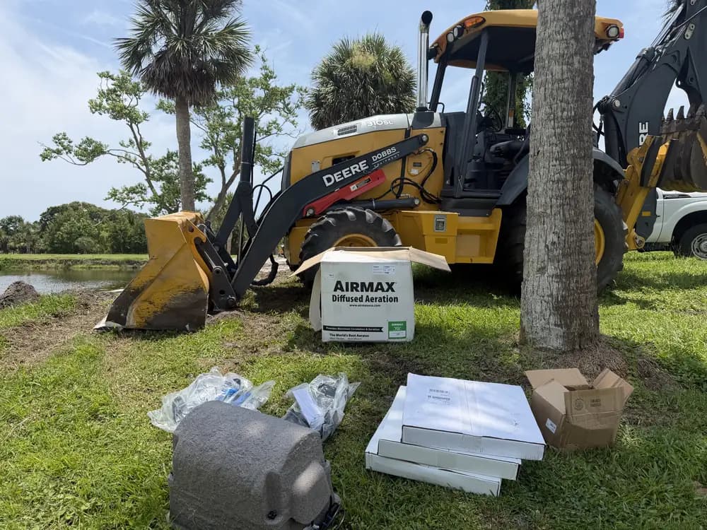 Diffused aeration equipment staged for installation next to a pond